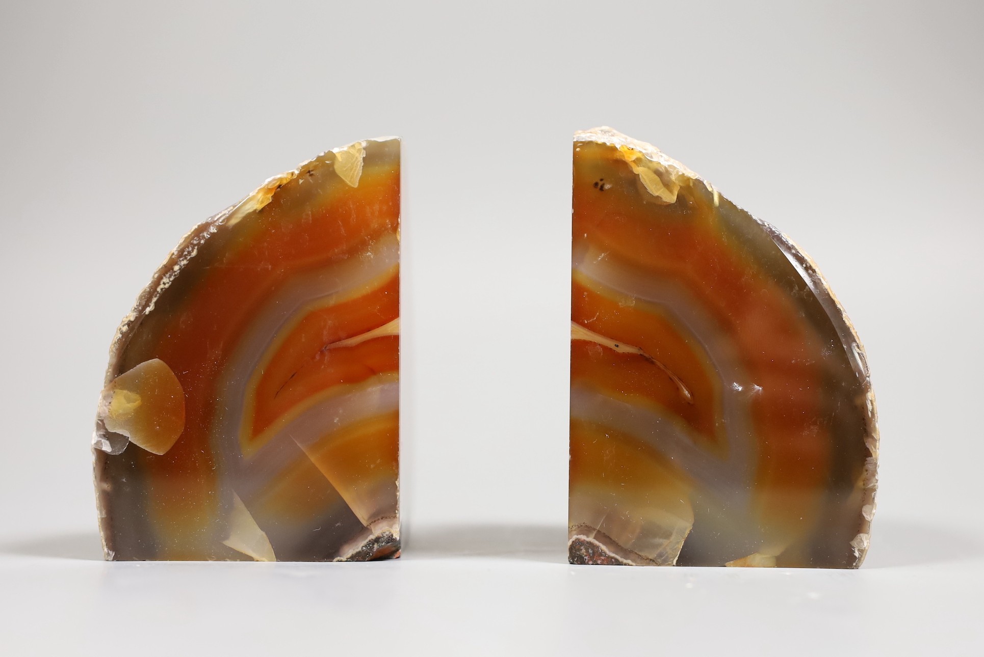 A pair of banded agate geode book ends, 10.5 cms high